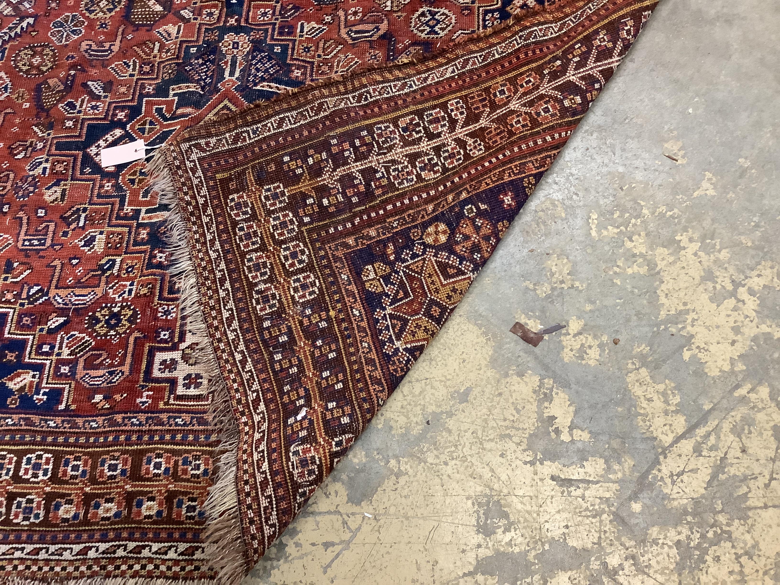 An antique Qashqai red ground rug, 260 x 174cm